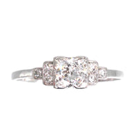 Art Deco platinum diamond solitaire ring featuring a 0.30-carat Old Transitional Cut diamond and diamond shoulders.