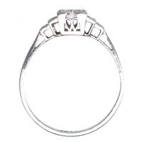 Art Deco platinum diamond solitaire ring showcasing a 0.30-carat Old Transitional Cut diamond with diamond shoulders.