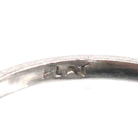 Close-up of the inside engraving on an Art Deco platinum ring showing the word 'PLAT'.