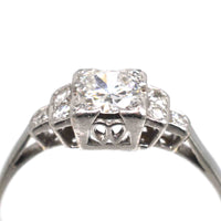 Art Deco Platinum Diamond Solitaire Ring featuring a 0.30-carat Old Transitional Cut diamond and diamond shoulders.