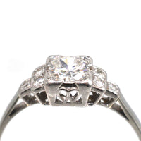 Art Deco Platinum Diamond Solitaire Ring with diamond shoulders showcasing a 0.30-carat Old Transitional Cut diamond.