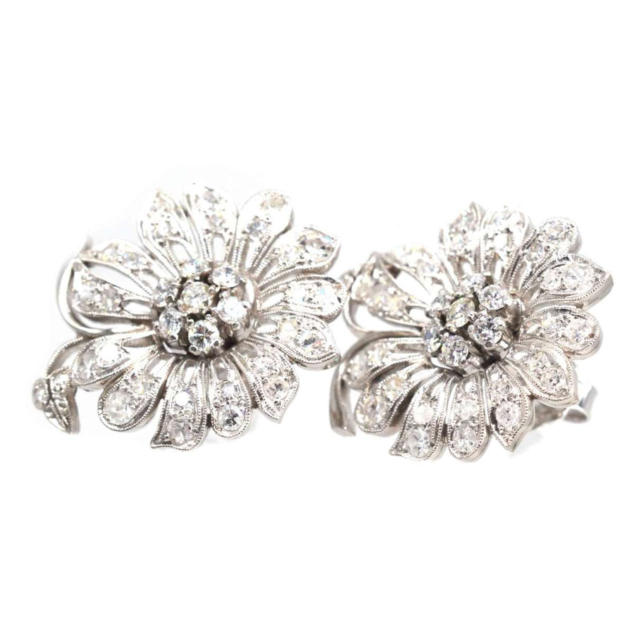 1940s 18ct white gold diamond flower cluster earrings with sparkling diamond petals and central clusters.