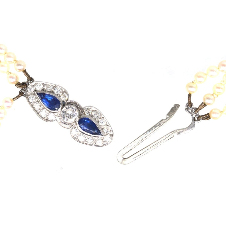 1940s triple strand cultured pearl necklace with sapphire and diamond clasp, showcasing royal blue sapphires and old cut diamonds.