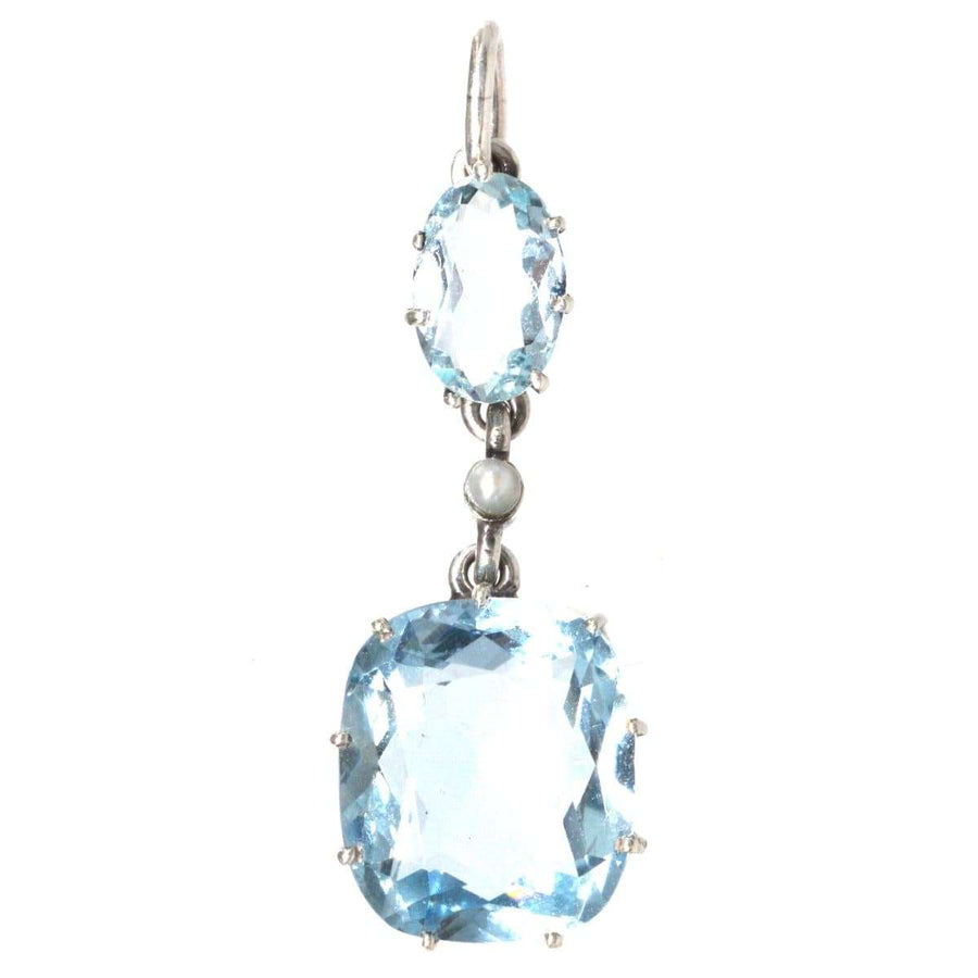 1940s platinum drop pendant featuring aquamarine and pearl, showcasing elegant blue stones and timeless design.