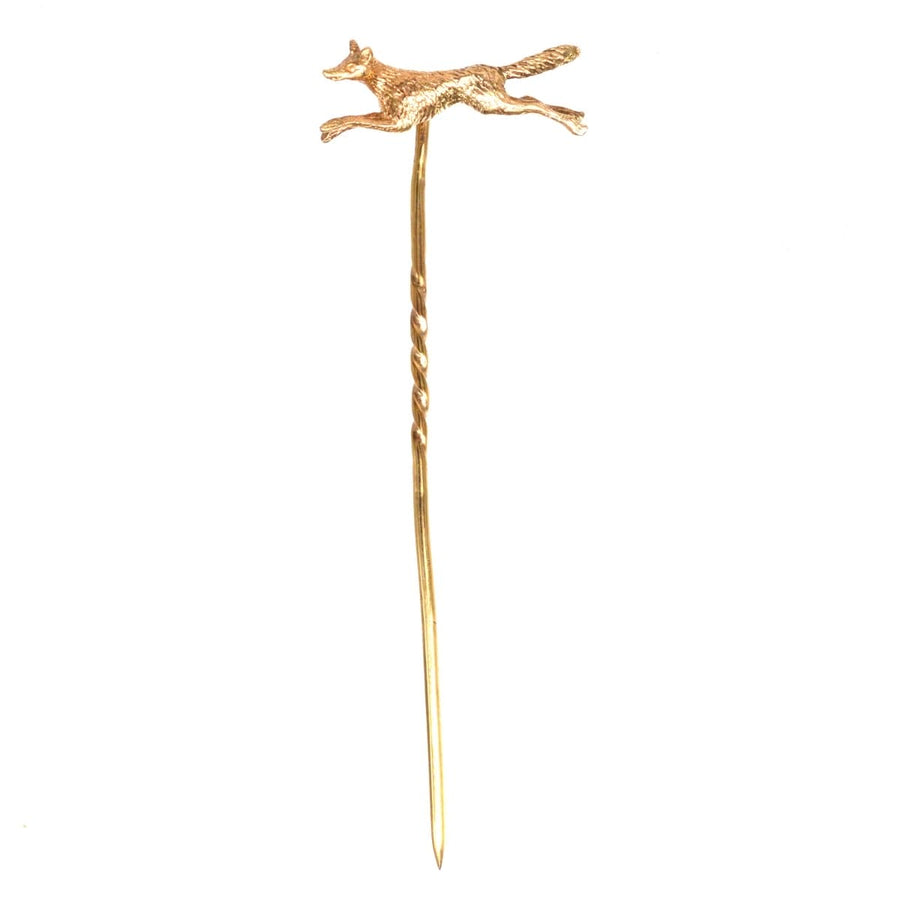 9ct gold running fox tie pin from the 1950s, showcasing a fox in motion, perfect for formal attire.