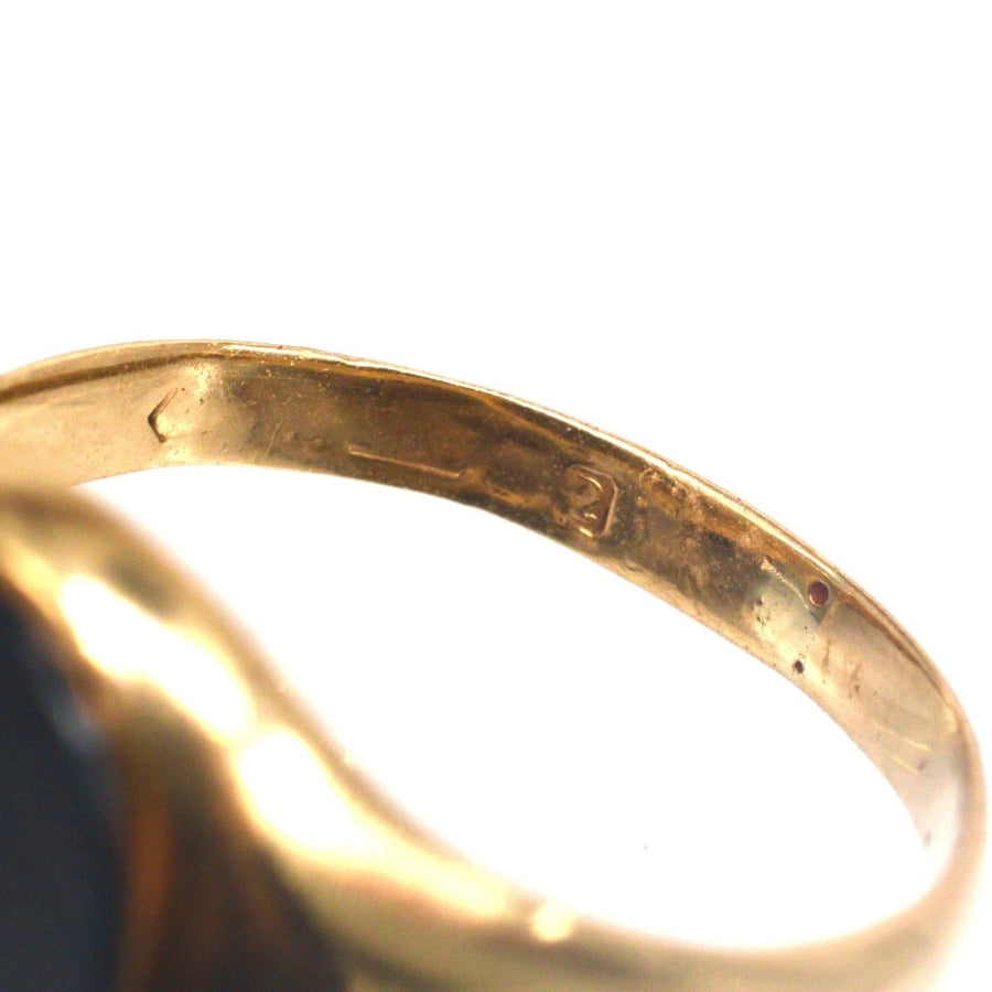 Close-up of the inner band of a 1960s 9ct gold signet ring with bloodstone, showcasing the Birmingham assay mark.