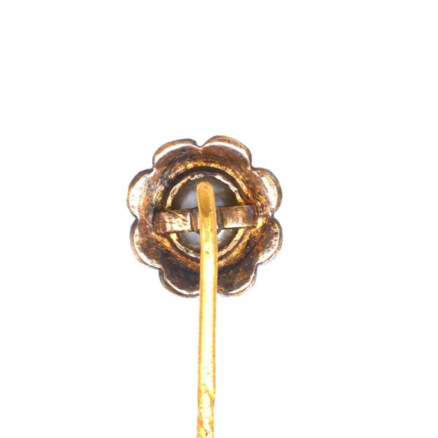 19th century gold tie pin with floral design and natural pearl center, showcasing intricate craftsmanship and elegance.