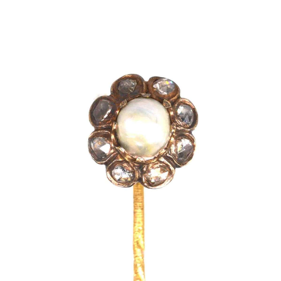 19th Century tie pin featuring a natural pearl center surrounded by rose-cut diamonds in gold setting.