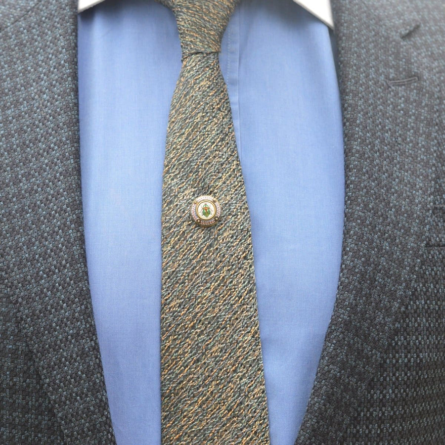 19th century Egyptian revival micromosaic tie pin featuring a scarab beetle on a patterned tie and formal shirt.