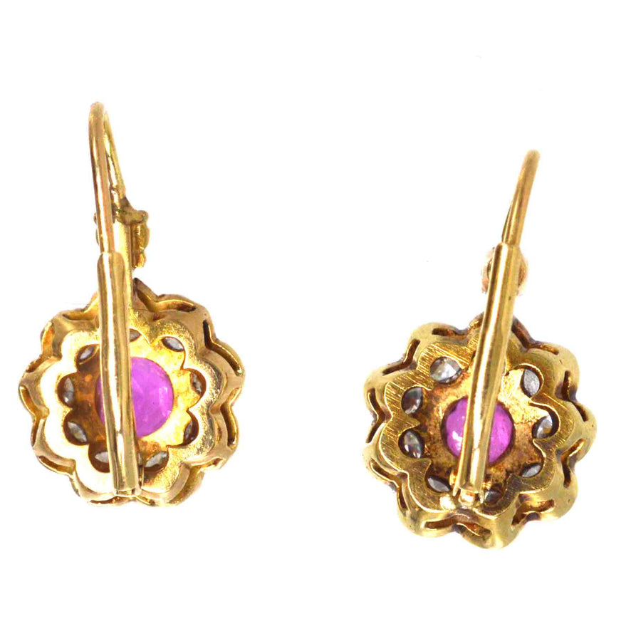 Edwardian 15ct gold earrings featuring ruby and diamond clusters, showcasing vintage elegance and timeless beauty.