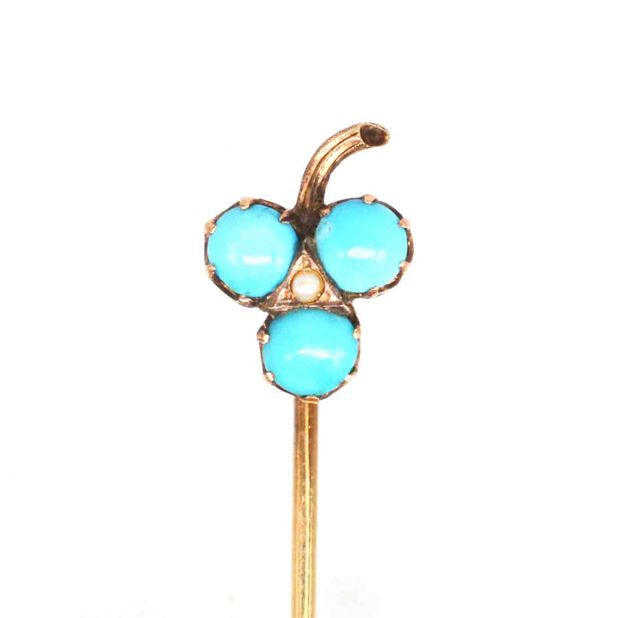 Edwardian 9ct gold shamrock tie pin with turquoise beads and pearl, a stylish symbol of luck and prosperity.