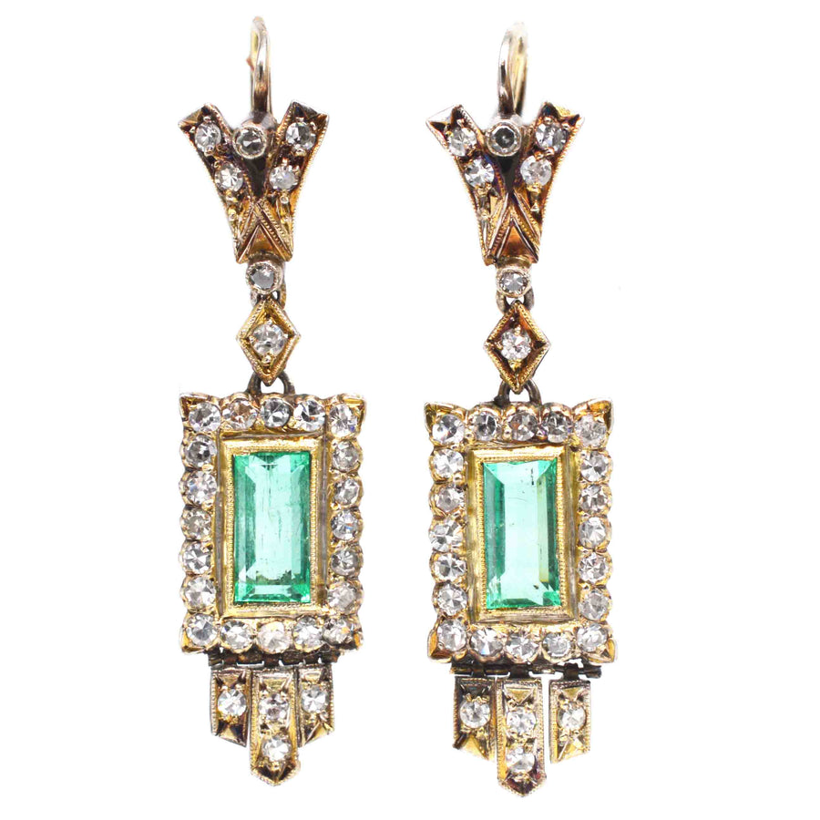 Art Deco 18ct gold drop earrings with emeralds and diamonds, showcasing geometric design and vintage glamour.