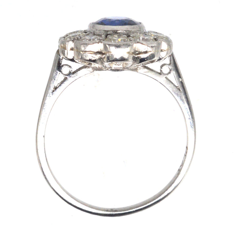 Vintage platinum sapphire and diamond cluster ring with a 1 carat sapphire and 1.2 carats of diamonds.