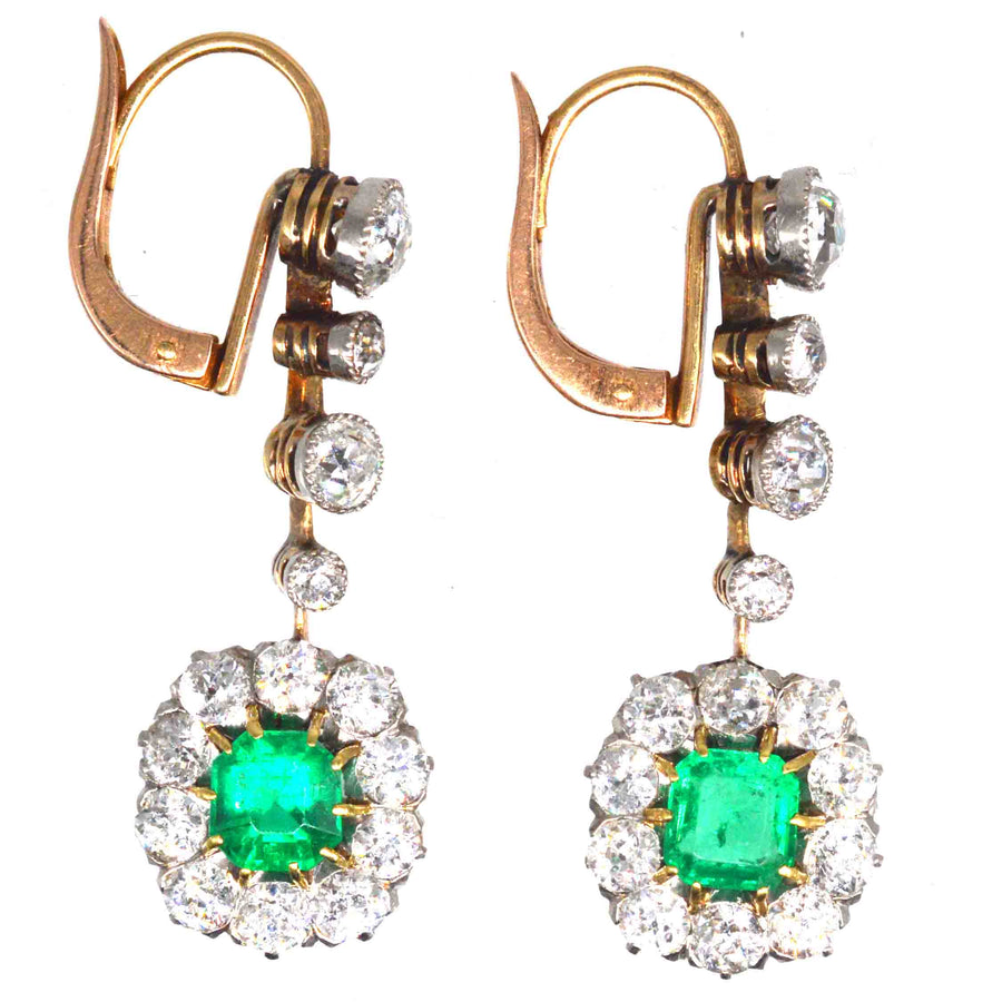 Edwardian Colombian emerald and diamond cluster drop earrings set in 18ct gold and platinum, featuring vibrant emeralds.