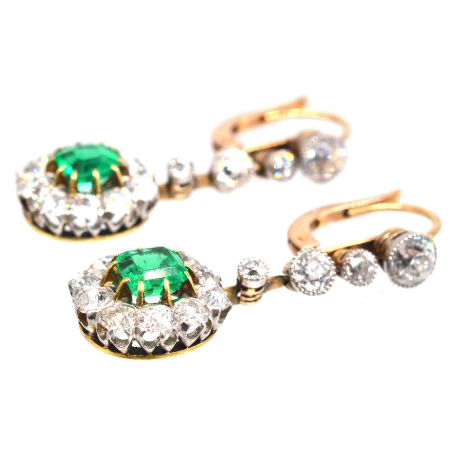 Edwardian emerald and diamond cluster drop earrings featuring Colombian emeralds and Old European Cut diamonds.