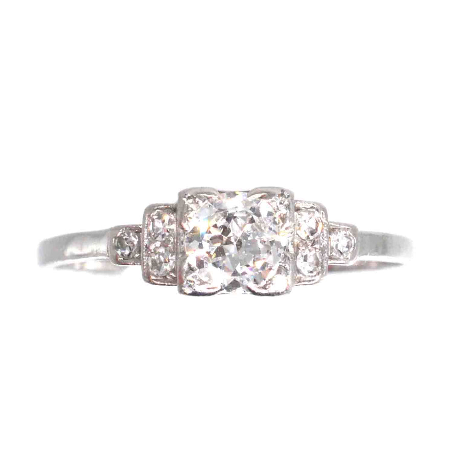 Art Deco platinum diamond solitaire ring featuring a 0.30-carat Old Transitional Cut diamond and diamond shoulders.