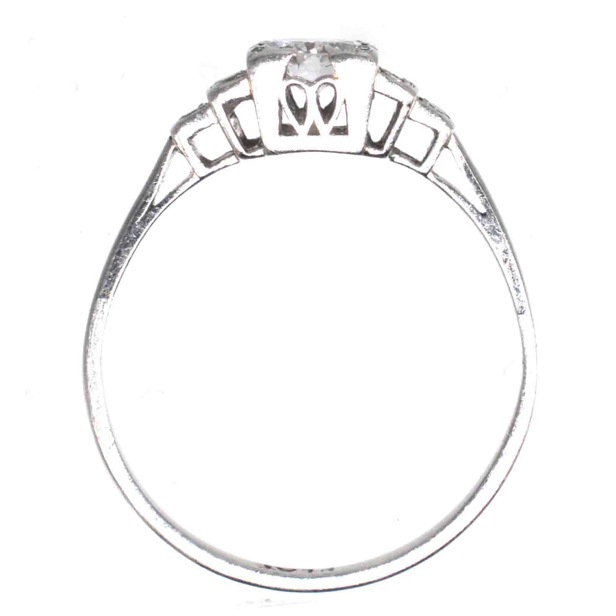 Art Deco platinum diamond solitaire ring showcasing a 0.30-carat Old Transitional Cut diamond with diamond shoulders.