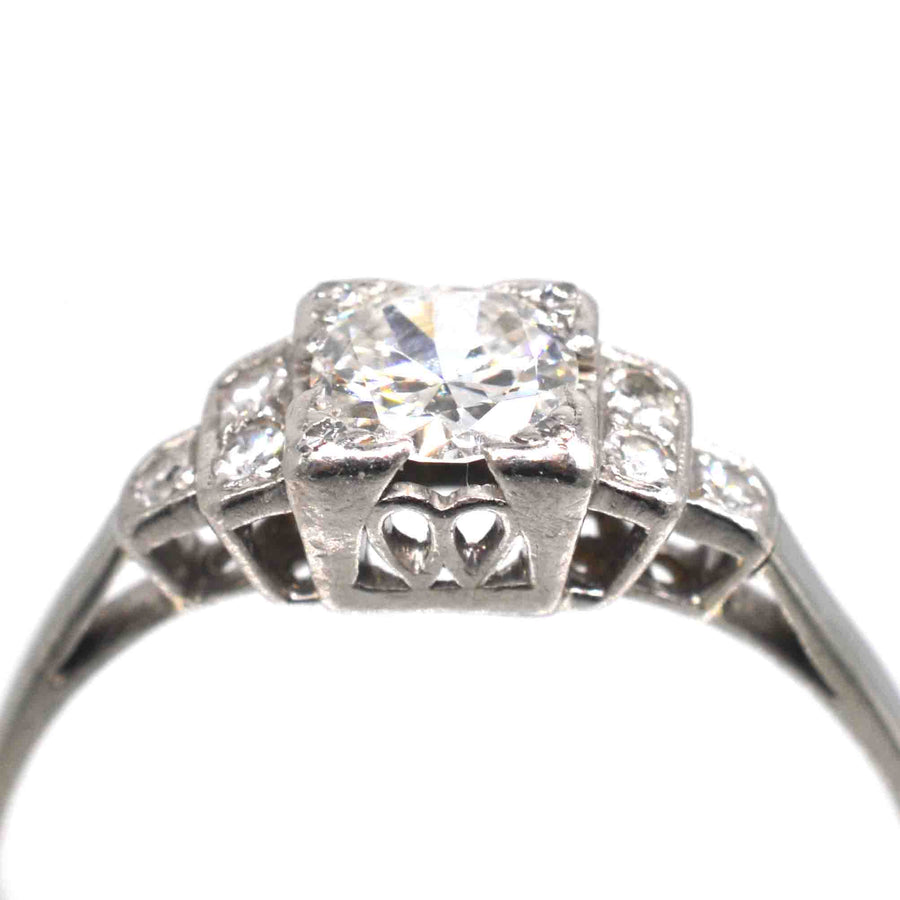 Art Deco Platinum Diamond Solitaire Ring featuring a 0.30-carat Old Transitional Cut diamond and diamond shoulders.