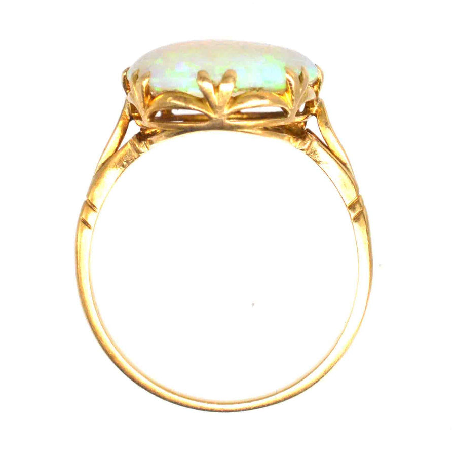 Edwardian 18ct gold large opal ring featuring a lustrous opal in a delicate setting, showcasing its vivid color play.
