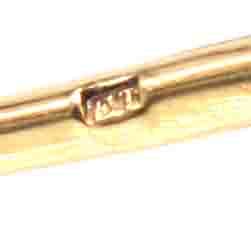 Close-up of the hallmark on 18ct gold, showcasing the quality and authenticity of the French Belle Epoque brooch.