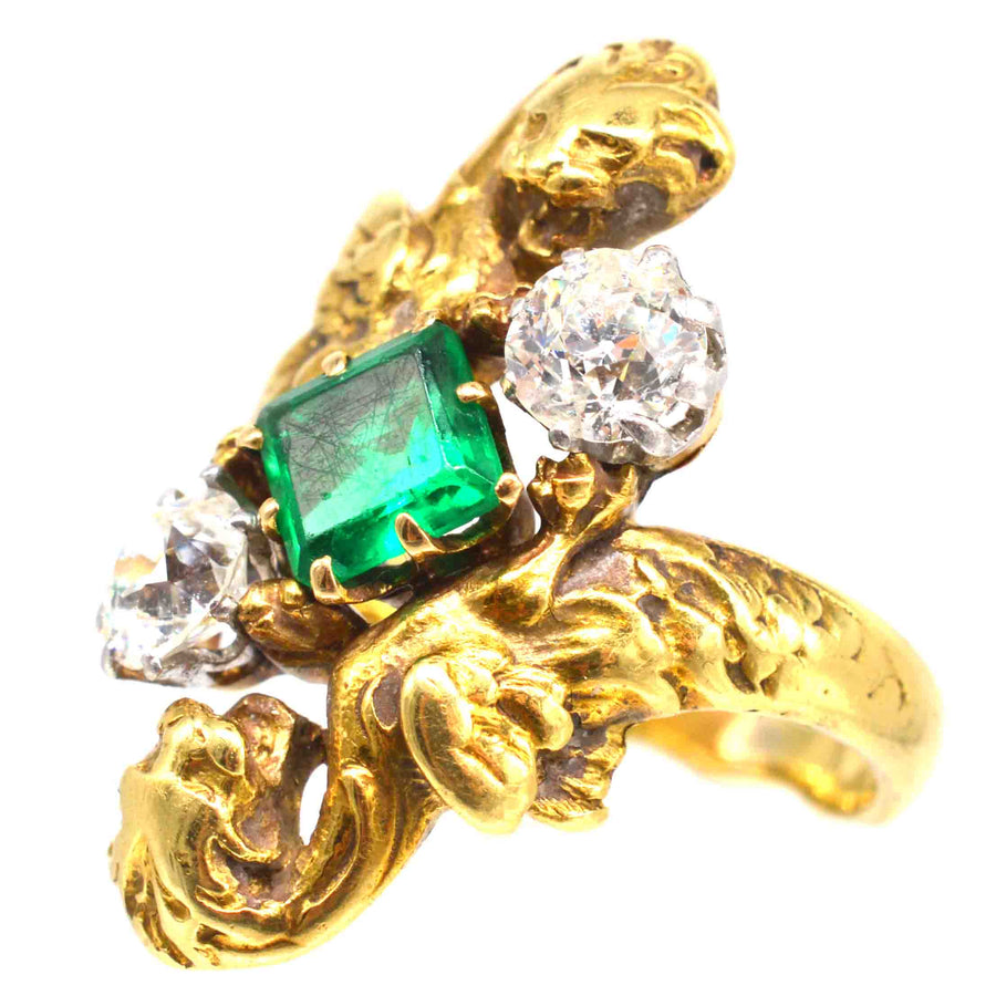 French Art Nouveau 18ct gold ring featuring Colombian emerald and two diamonds, designed with majestic griffins.