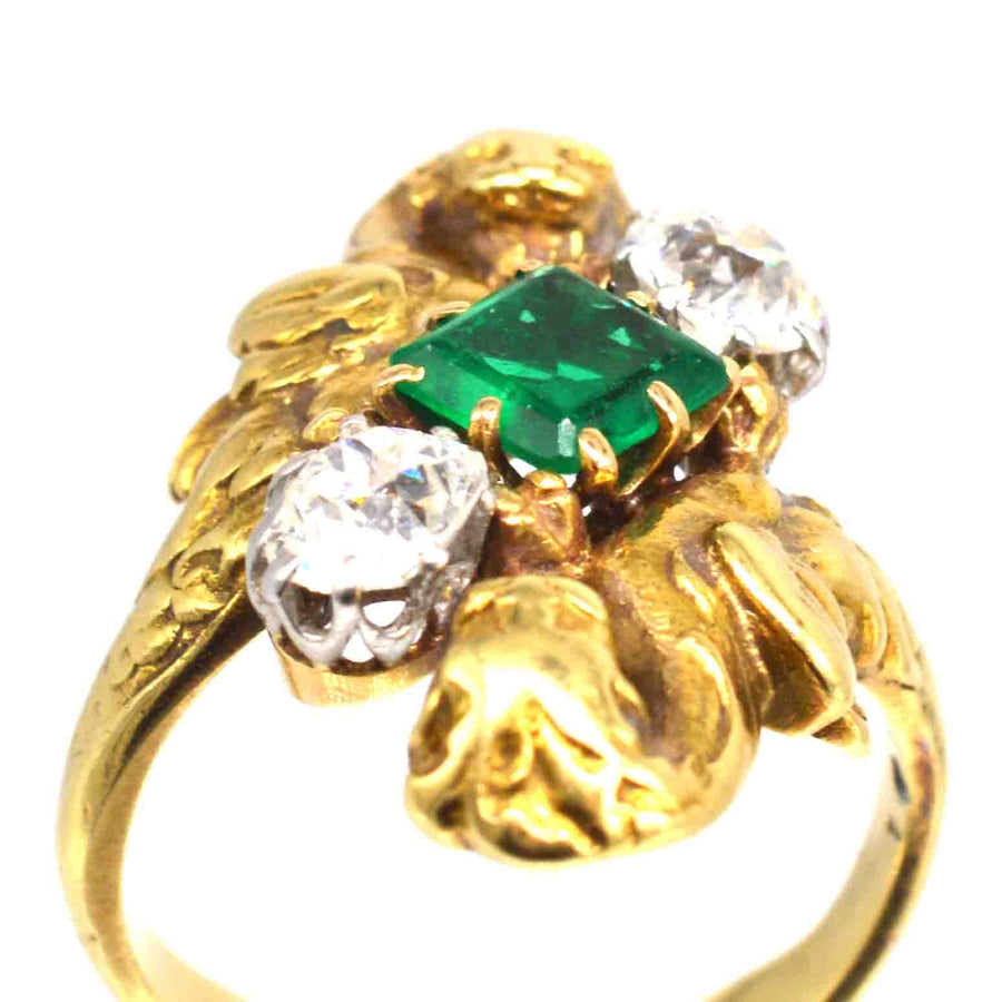 French Art Nouveau 18ct gold griffin ring featuring Colombian emerald and two diamonds.