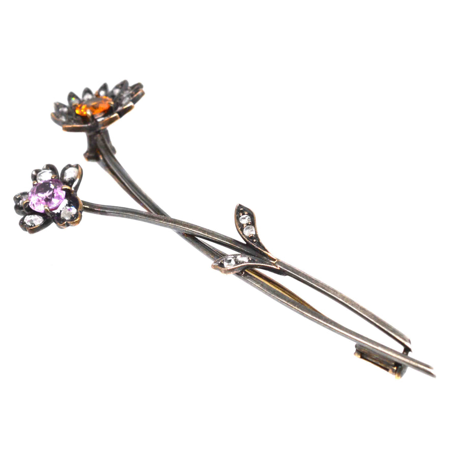 Austro-Hungarian gold brooch featuring pink and imperial topaz floral design with diamond accents.
