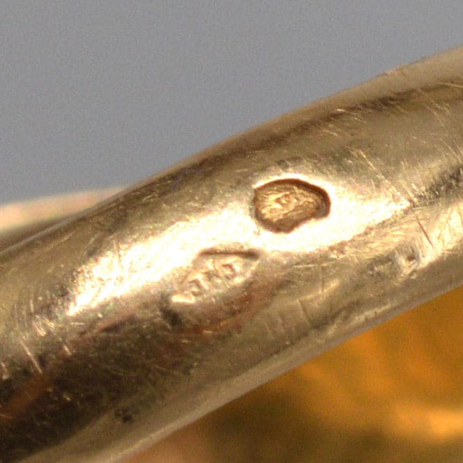 Close-up of hallmarks on an antique French 18ct gold ring, showcasing intricate detailing and craftsmanship.