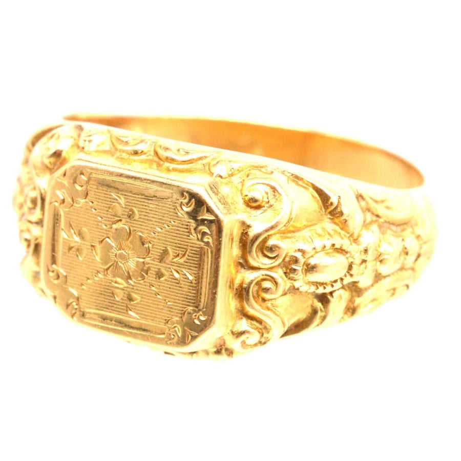 Antique 18ct gold French ring with engraved floral details and intricate swirls on the shoulders.