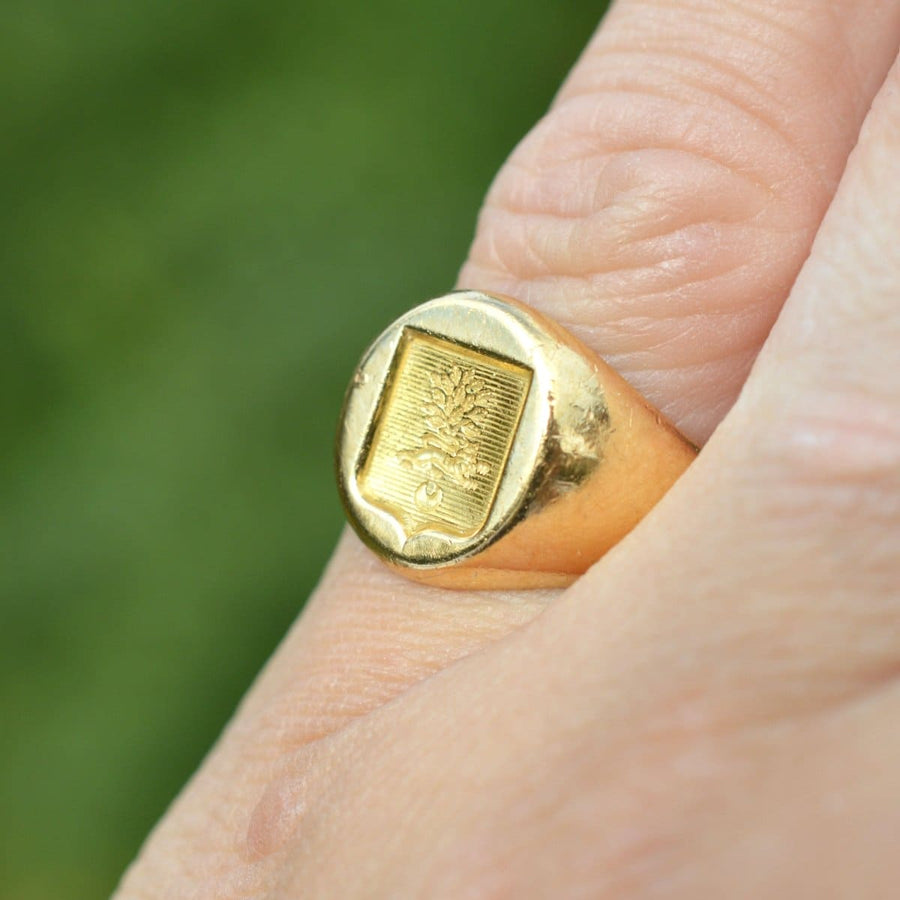 Antique French 18ct gold signet ring with hand engraved armorial shield and lion passant detail.
