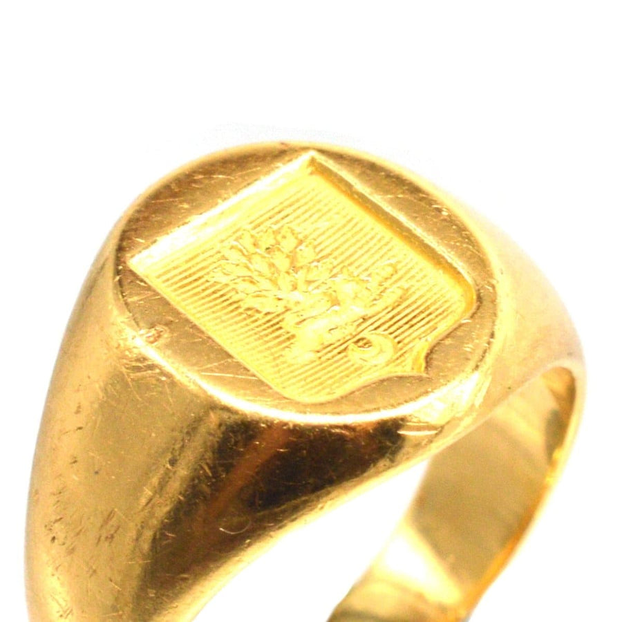 Antique French 18ct gold signet ring with hand-engraved armorial shield, featuring a lion and tree design.
