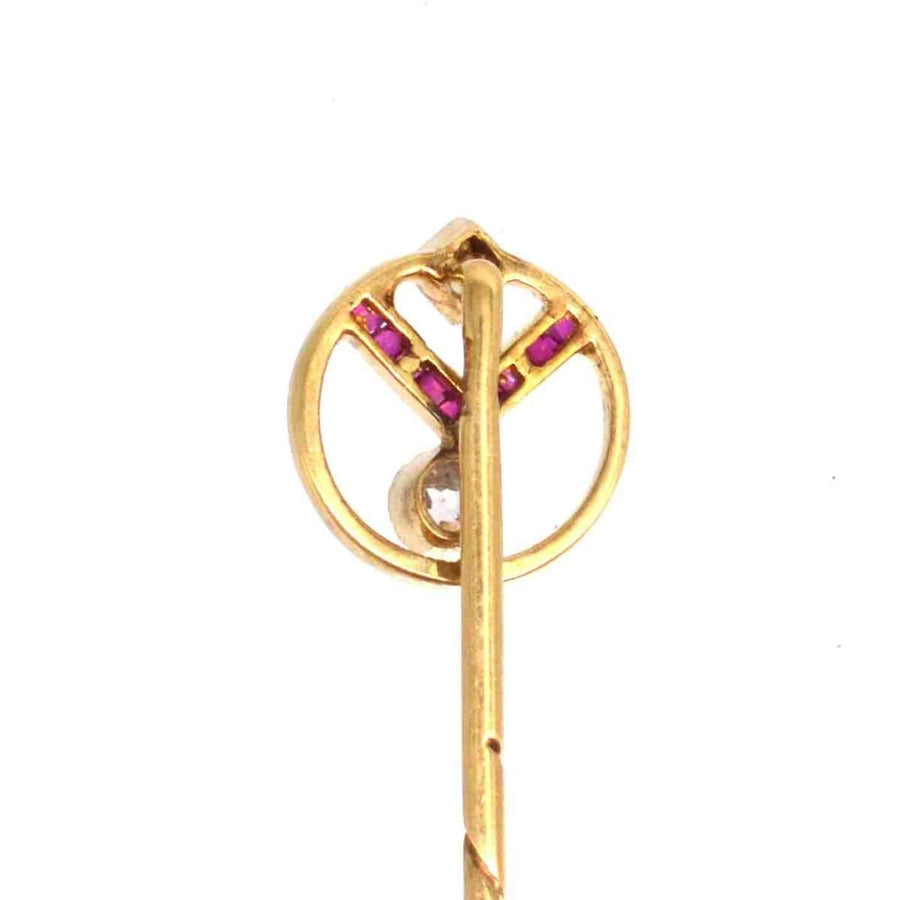 Art Deco 14ct gold pin with ruby and diamond geometric design, symbolizing vintage elegance.