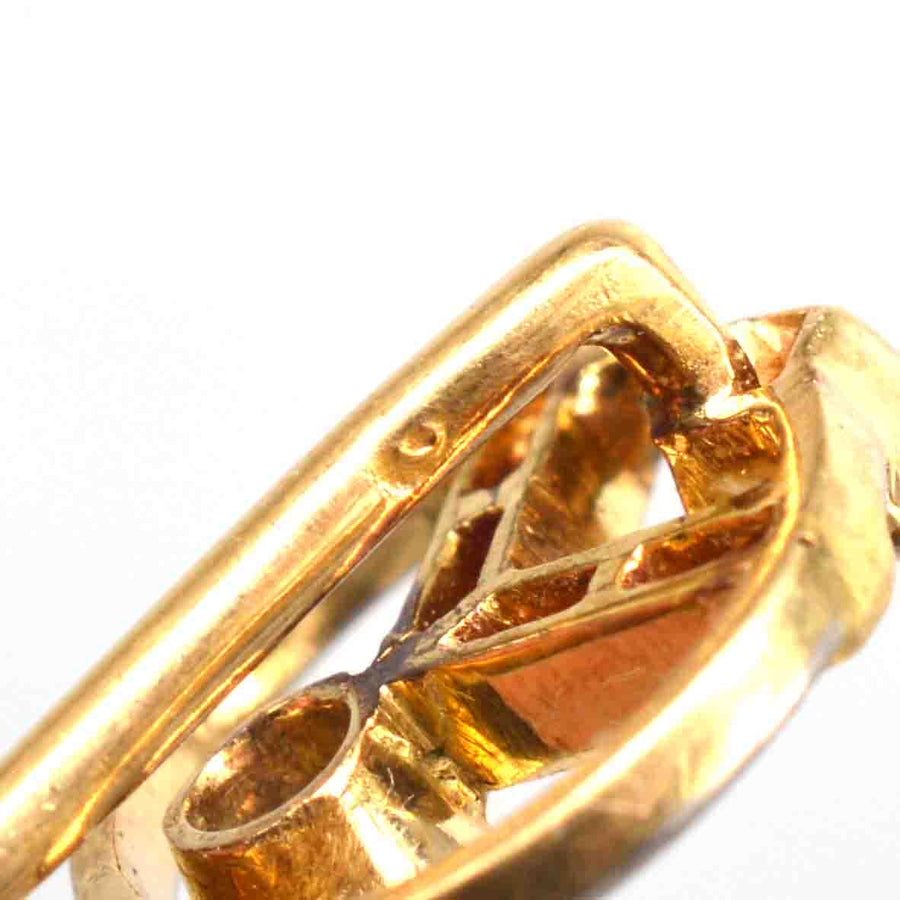 Close-up detail of an Art Deco 14ct gold pin showcasing its geometric design and craftsmanship.