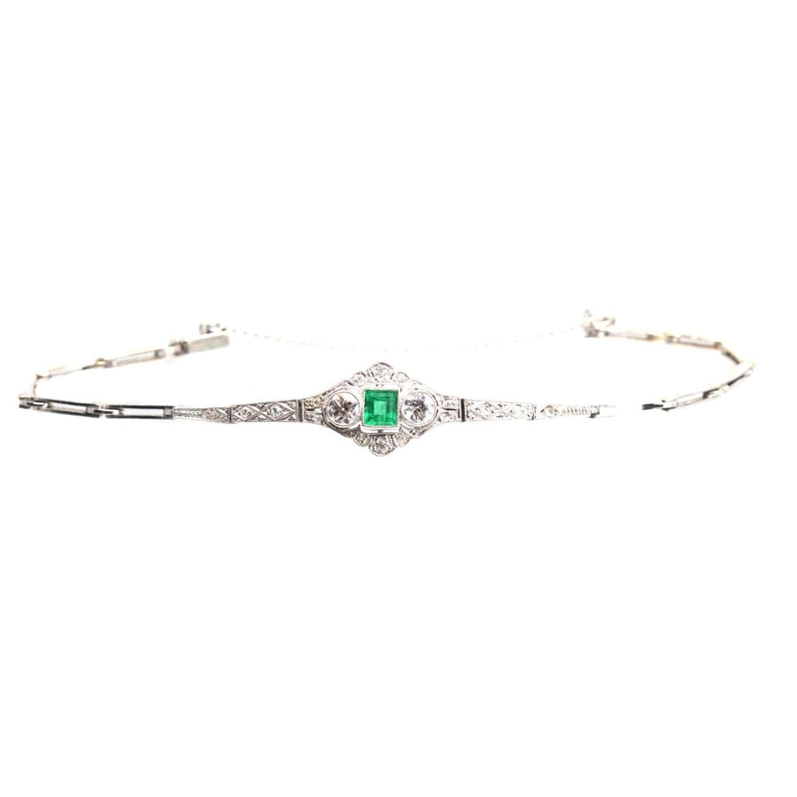 Art Deco 14ct white gold bracelet featuring a square-cut emerald and two old European cut diamonds in geometric design.
