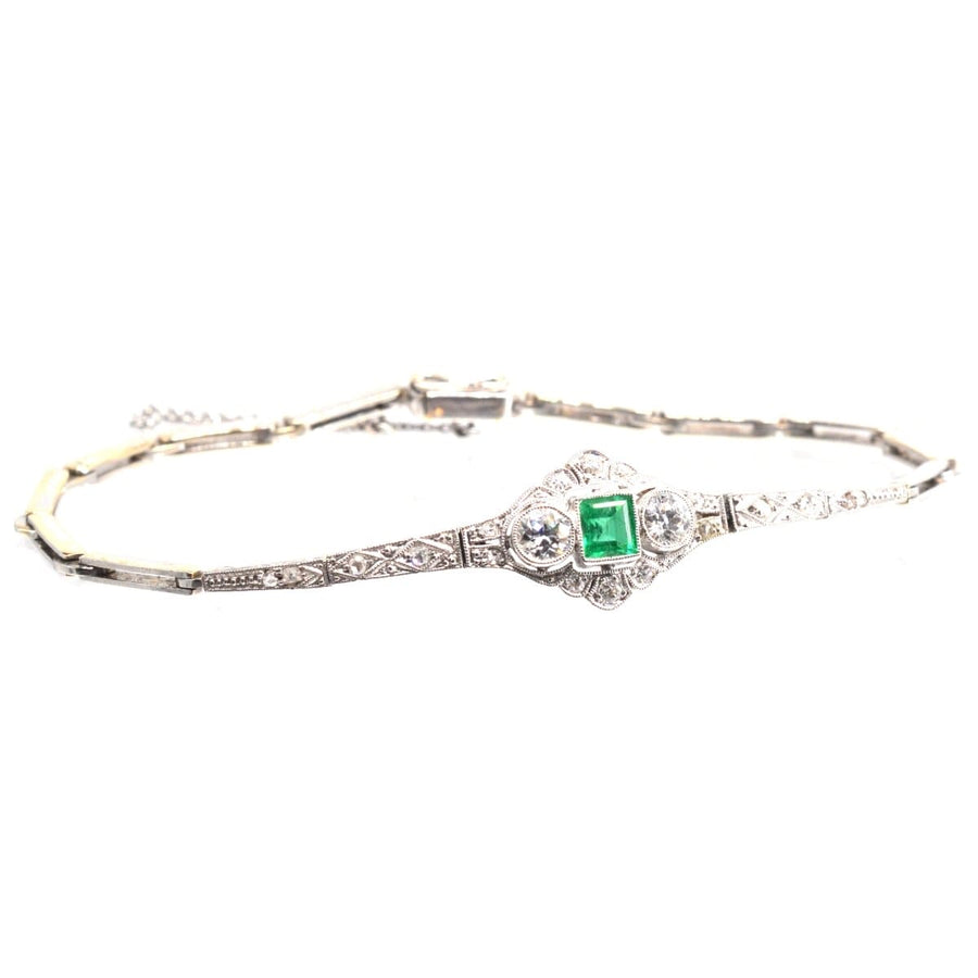 Art Deco 14ct white gold bracelet featuring a square-cut emerald and two old European cut diamonds.