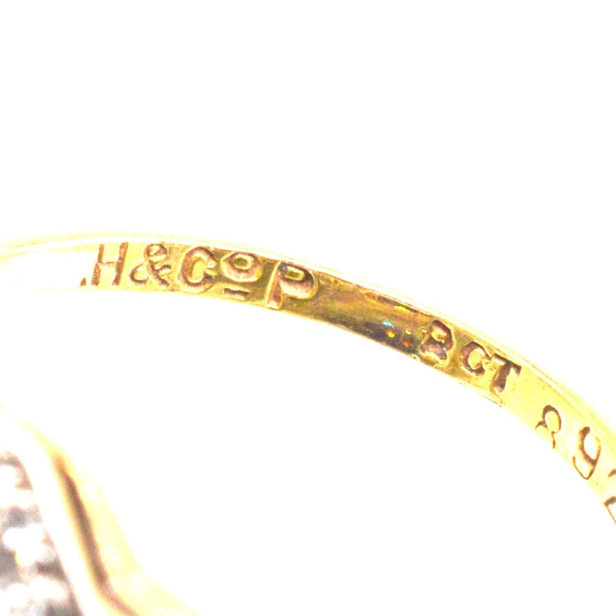 Close-up of the hallmark on an Art Deco ring showing H&CoP and carat marks for authenticity.