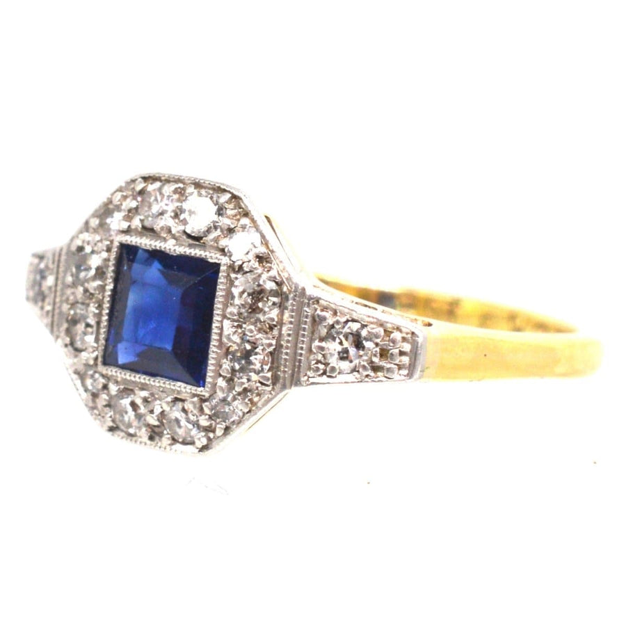 Art Deco 18ct and Platinum ring featuring square cut sapphire and diamond halo, perfect for engagement or September birthday.