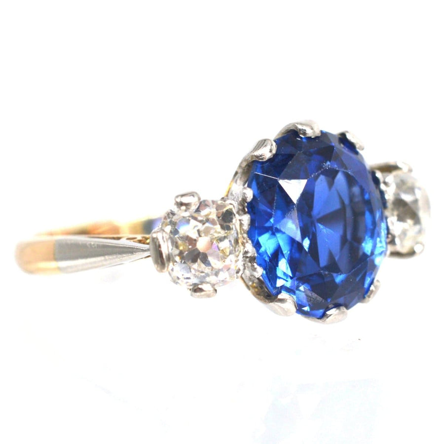 Art Deco 18ct gold and platinum ring featuring a 5.25ct Ceylon sapphire and two diamond side stones.
