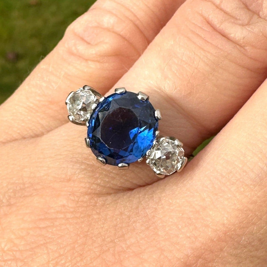 Art Deco 18ct gold and platinum ring featuring a 5.25ct natural Ceylon sapphire and two diamonds on a hand.