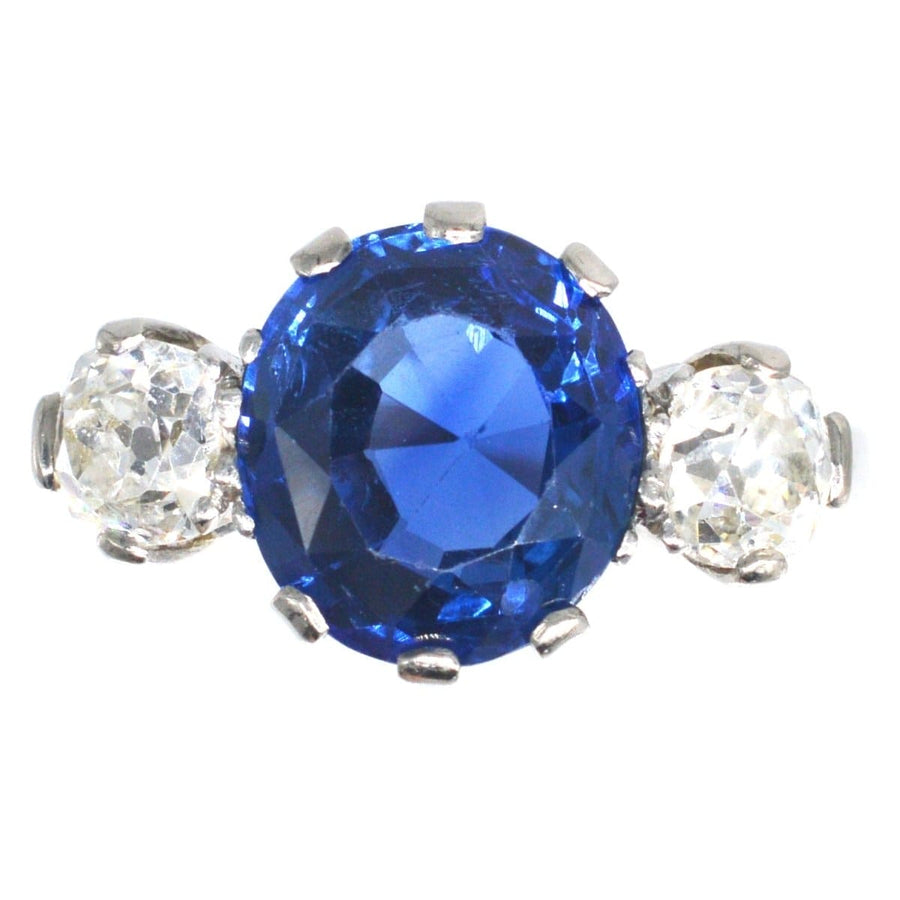 Art Deco 18ct gold ring featuring a 5.25 carat Ceylon sapphire and diamond side stones.