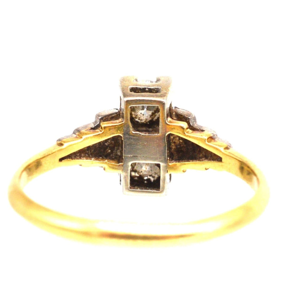Art Deco 18ct gold and platinum two stone diamond ring with geometric design and small shoulder diamonds.