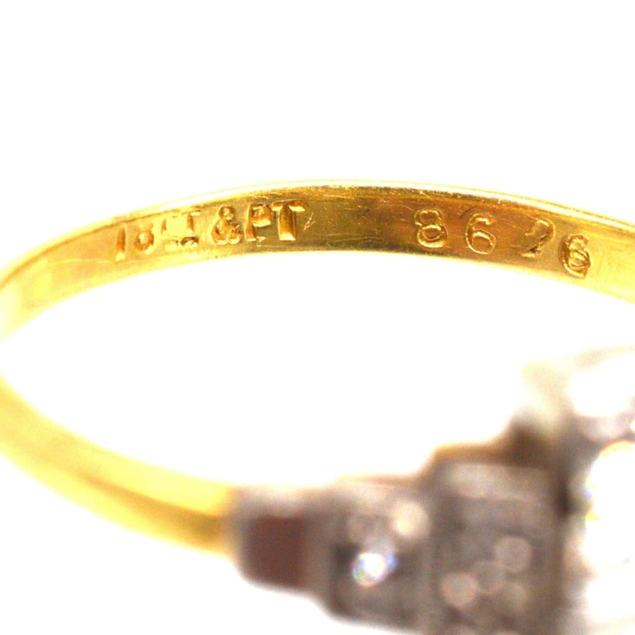 Close-up of 18ct gold and platinum hallmark on Art Deco diamond ring, showcasing exquisite craftsmanship and quality.