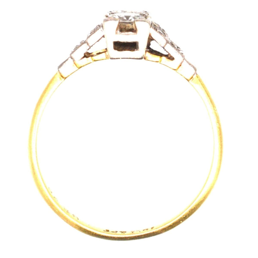 Art Deco 18ct gold and platinum two stone diamond ring with small diamonds on shoulders, geometric design.