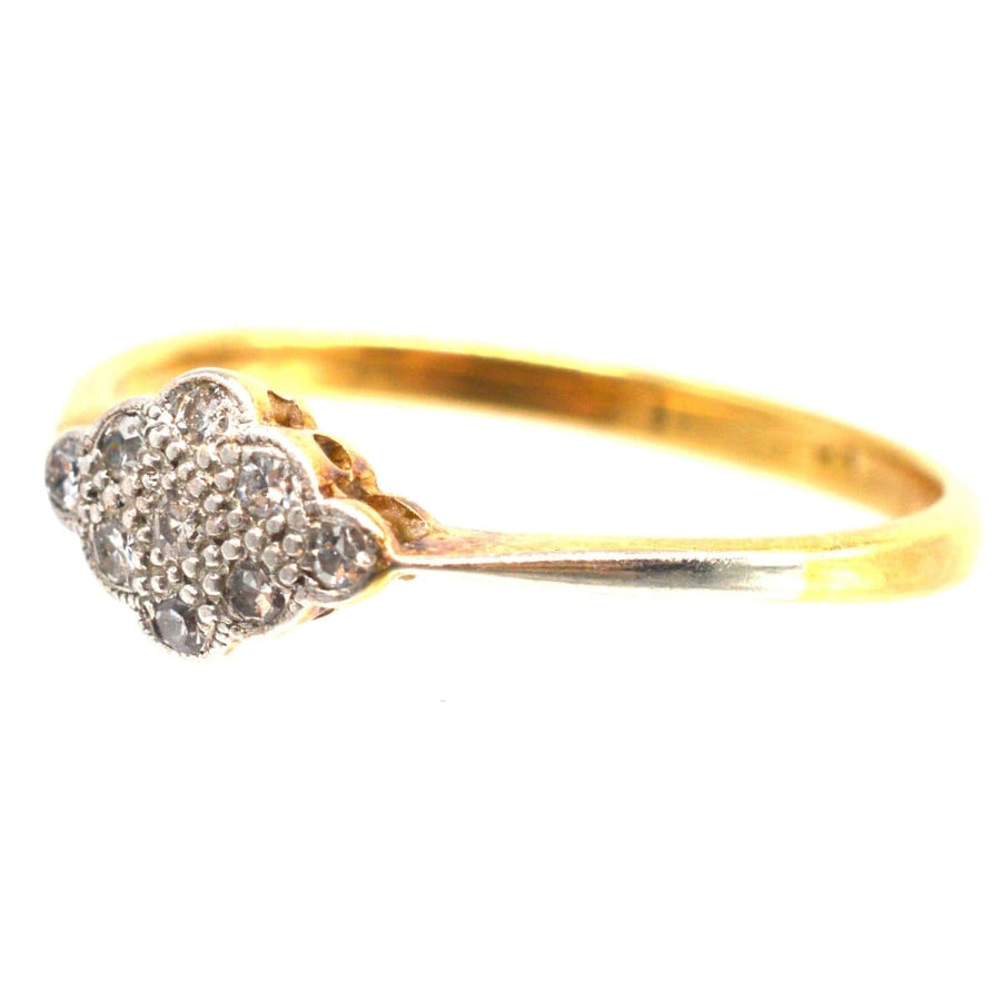 Art Deco 18ct gold diamond cluster ring featuring a floral design, showcasing nine diamonds in elegant setting.