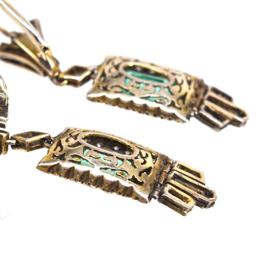 Art Deco 18ct gold drop earrings featuring emerald and diamond accents with intricate geometric design.