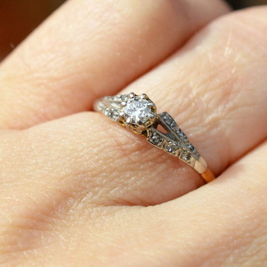 Art Deco 18ct Gold & Platinum diamond solitaire ring with diamond shoulders on a hand, perfect for engagements.