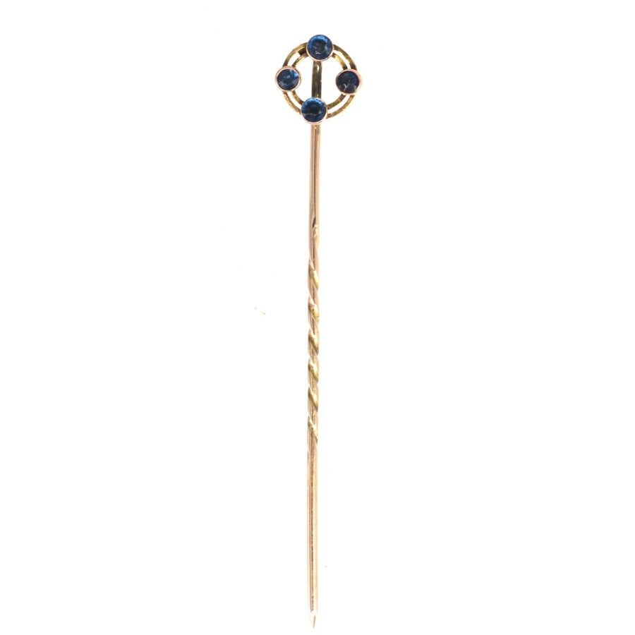 Art Deco 9ct gold circular tie pin with four blue sapphires, elegant geometric design from Chester, 1924.