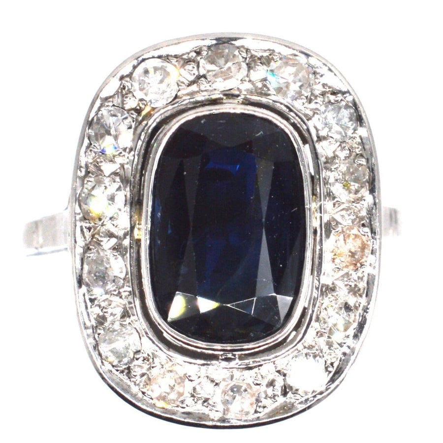 Art Deco French ring featuring a large dark sapphire surrounded by diamonds, ideal for an engagement ring.