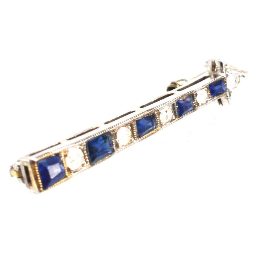 Art Deco arrow brooch featuring sapphires and diamonds, perfect for enhancing any lapel style.