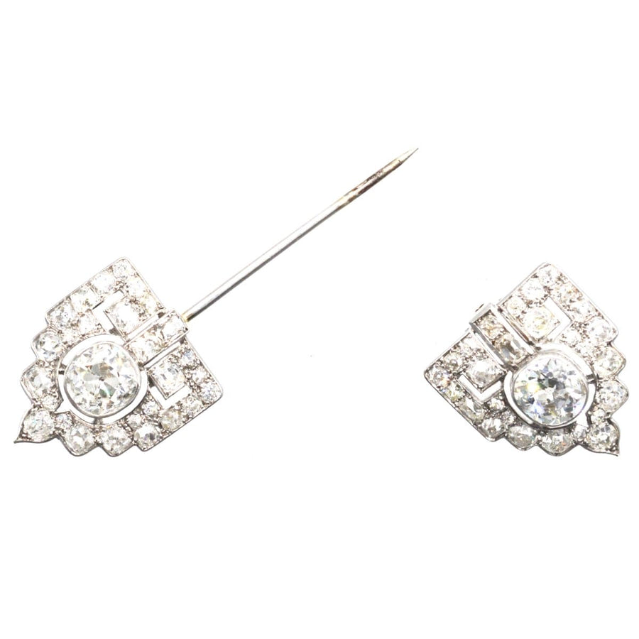 Art Deco platinum brooch featuring intricate design and diamond accents, showcasing over 6 carats of old cut diamonds.